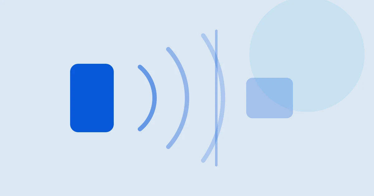 En telefon som holdes mot en terminal, med rekkevidde ut over landegrensen